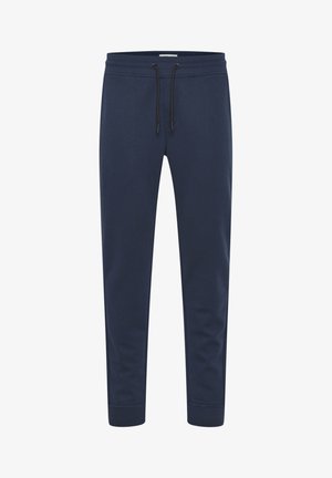 Tumši zili sporta bikses, kas izgatavotas no mīksta auduma, ar auklu jostasvietā, sašaurinātiem kāju galiem un ribotām aprocēm pie potītēm.