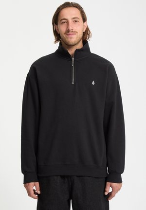 Zwarte zip-up sweatshirt met een hoge kraag, lange mouwen, geribde manchetten en een klein logo op de borst. Zachte stofstructuur.