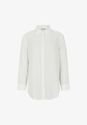 Bílá blůza s dlouhým rukávem, špičatým límcem, zapínáním na knoflíky a manžetami, vyrobená z hladkého materiálu s mírně průsvitnou texturou.