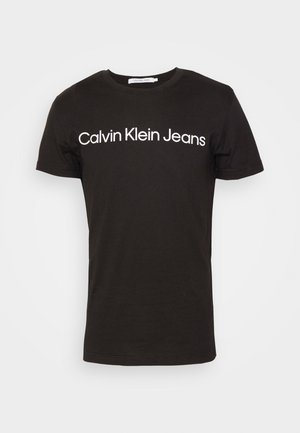 Černé bavlněné tričko s kulatým výstřihem a krátkými rukávy; logo "Calvin Klein Jeans" bílé barvy napříč hrudníkem.