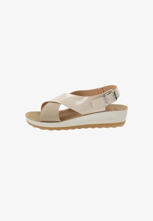 Sandal beige chiaro con cinturini incrociati, fibbia alla caviglia regolabile, soletta imbottita e una suola in platform bianca con fondo in gomma texturizzata.