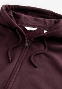 Sweat à capuche violet foncé avec fermeture éclair, cordons, fermeture éclair visible et doublure intérieure en polaire, taille moyenne de la marque NEXT.