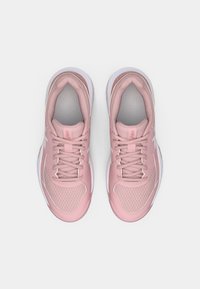Světle růžové sportovní boty s síťovými panely, polstrovaným límcem a bílou gumovou podrážkou. Funkce plochých tkaniček a strukturované špičky.