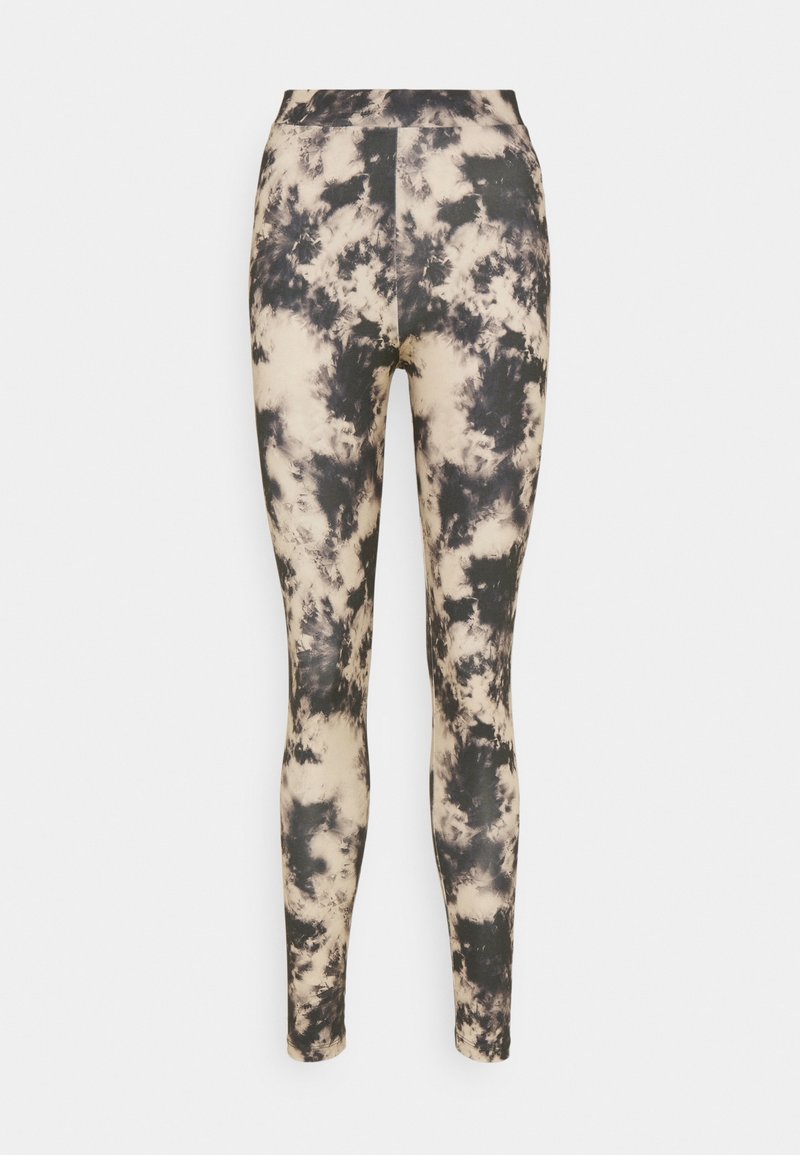 Leggings taille haute noirs et beiges avec un design tie-dye, ajustés jusqu'à la cheville, sur fond blanc.
