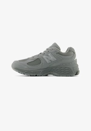 Grey athletic sneaker with mesh inserts, thick cushioned sole, lace-up design, and a textured pattern on the midsole and outsole.