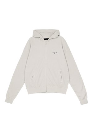 Haut de survêtement zippé gris clair en tissu côtelé, doté d'une capuche, de deux poches latérales et d'un petit logo brodé sur le côté gauche de la poitrine.