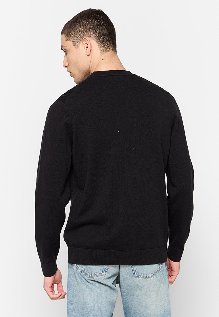 Schwarzer, gestrickter Pullover mit langen Ärmeln und Rundhalsausschnitt. Verfügt über einen gerippten Saum und Bündchen in einem strukturierten Stoff. Rückansicht dargestellt.