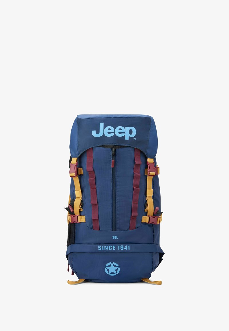Mochila azul marino con correas amarillas y burdeos, gran cremallera frontal, logo de Jeep y las inscripciones "30L" y "DESDE 1941" en la parte frontal.