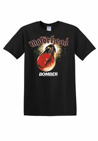 T-shirt en coton noir avec un imprimé graphique d'une bombe à tête rouge, entourée d'explosions, et le texte "Motörhead BOMBER" en police stylisée.