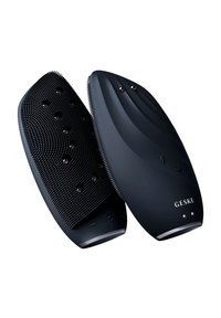 Svart handhållen enhet med ergonomisk design. Ena sidan har texturerade gummiborstar, den andra en slät yta med LED-indikatorer.