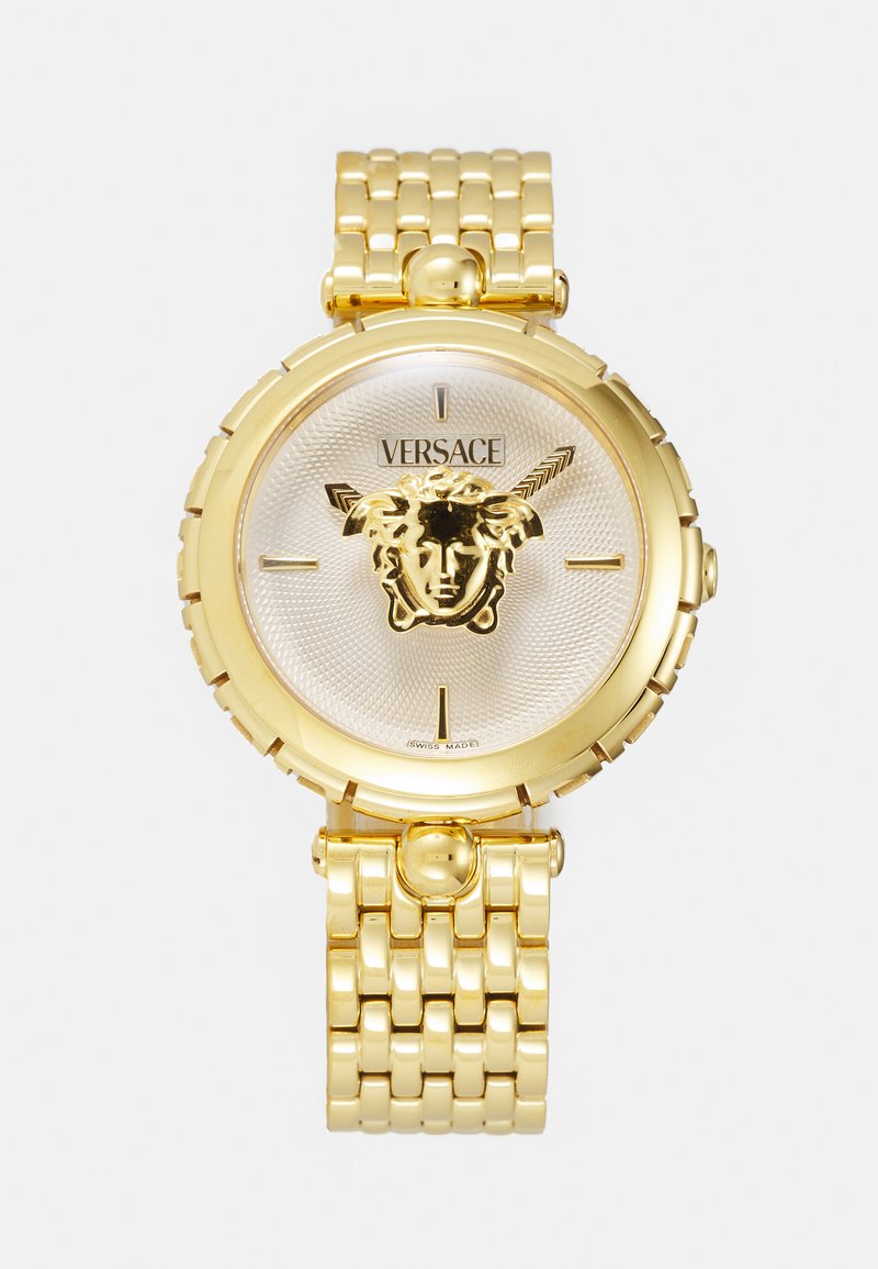 Zlatý náramkový hodinky Versace so strieborným textúrovaným ciferníkom, na ktorom sa nachádza emblém Medusa, a leštený náramok s prepojeným dizajnom.