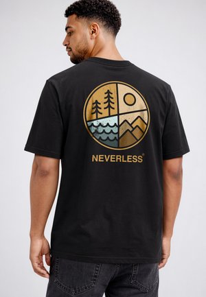 Man wearing black T-shirt with circular outdoor design showing trees, sun, water, and mountains above the word "NEVERLESS" on the back.