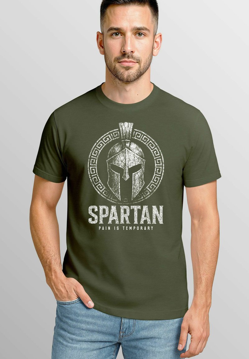 Olive green cotton t-shirt featuring a distressed Spartan helmet graphic and text "SPARTAN PAIN IS TEMPORARY" in white. Short sleeves, crew neck.