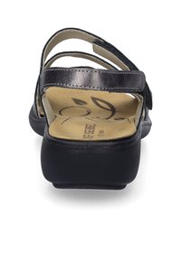 Black sandal featuring a textured upper, adjustable straps, padded footbed, and a low-profile rubber sole. Design is functional and lightweight.