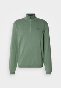 Light green zip-neck pullover made of knit fabric. Features long sleeves, ribbed texture on shoulders, and black "BOSS" logo on chest.