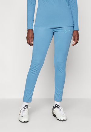 Blå leggings lavet af strækbart materiale med en glat overflade. Har et lille Nike-logo på venstre hofte og en tætsiddende pasform.