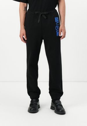 NILTRO - Tracksuit bottoms - black
