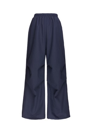 Marineblaue weit geschnittene Hose mit elastischem Bund und strukturiertem Stoff, auf weißem Hintergrund präsentiert.