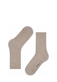 Calzini a coste in beige chiaro, con punta e tallone rinforzati. Realizzati in materiale morbido con una vestibilità comoda. Logo del marchio visibile sul lato.