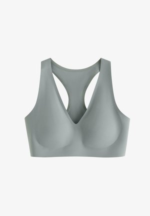 Sømløs lysegrå sports-bh med polstrede kopper og racerback-design, med en dyb V-udskæring.