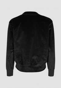 Veste en velours côtelé noire à manches longues, poignets et ceinture côtelés, vue de dos sur un fond uni clair.