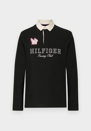 Black long-sleeve polo shirt with a beige collar, featuring "HILFIGER Racing Club" in white lettering and a red embroidered logo detail.