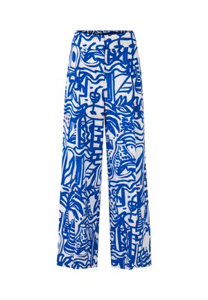 Wide-leg pants in white fabric featuring a bold blue abstract pattern with various shapes, lines, and floral designs.