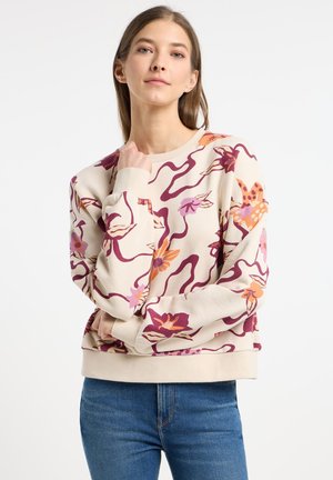 Light beige sweatshirt with floral and wavy purple patterns. Features long sleeves and a ribbed crew neck. Soft, textured fabric.