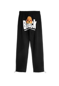 Pantalones de chándal negros con un diseño de perro de felpa y letras blancas en negrita. Incluyen cinturilla elástica y puños de tobillo con cremallera.