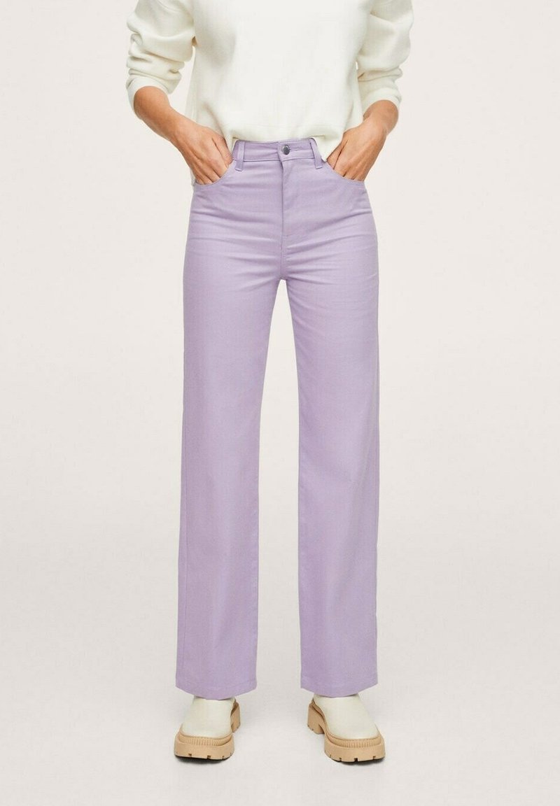 Pantalons larges de couleur violet clair en mélange de coton, avec une taille haute et une texture lisse, assortis à des chaussures à plateforme beiges.