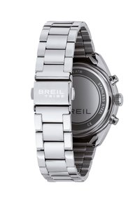 Montre en acier inoxydable avec un bracelet à maillons argenté. Boîtier rond avec un cadran noir et le nom de la marque gravé. Résistante à l'eau jusqu'à 5 ATM.