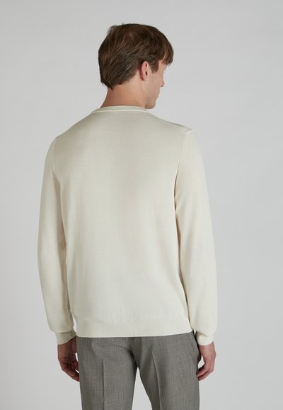 Light cream pullover sweater with a round neck, long sleeves, ribbed cuffs and hem. Soft texture, minimal design, and lightweight material.