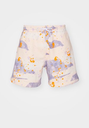 Svømmebukser i lys creme med abstrakte lila og orange splattermønstre. Lavet af blødt stof, med en elastisk talje og snor.