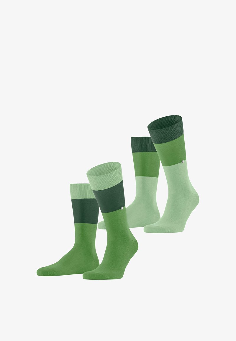 Deux paires de chaussettes bicolores vertes avec trois nuances horizontales, présentées debout avec un petit logo sur la zone de la cheville.