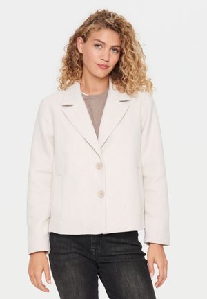 Light beige jacket with a structured design, single-breasted closure, notch lapels, and two side pockets. Soft texture and medium weight.