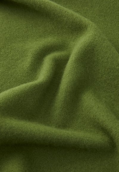 Green wool fabric with a soft, smooth texture, exhibiting a slightly brushed finish and subtle variations in shade and depth.