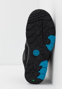 Zwarte rubberen schoenzool met een gestructureerd patroon en blauwe accenten, voorzien van een logo en een niet-afgevende grip. 