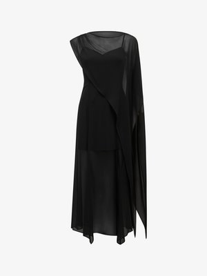 Zwarte jurk van vloeiende stof, met een asymmetrisch ontwerp, doorzichtige overlay en een nauwsluitend lijfje met een afgeronde halslijn.