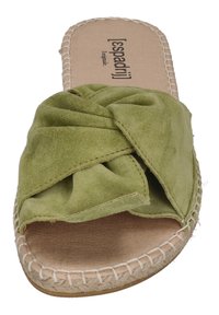 Green suede slide sandal featuring a knotted design, a natural leather insole, and a braided jute sole. Flat, open-toe style.