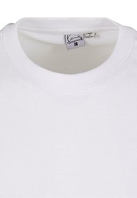 White cotton t-shirt featuring a crew neck with smooth edges. Label stitched inside collar indicating size 'L'. Minimalist design, no patterns.