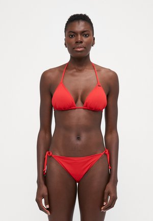 Red bikini set featuring a triangular top with thin straps and adjustable ties on the low-rise bottom, made from smooth, stretchable fabric.