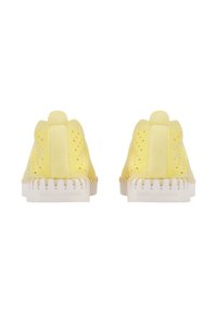 Yellow shoes with a textured upper, featuring cut-out patterns and a white rubber sole. The back has a tab for easy wearing.