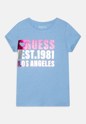 Jasnoniebieski t-shirt z krótkim rękawem z różowym i białym tekstem "GUESS EST.1981 LOS ANGELES" oraz różowym sercem na piersi.