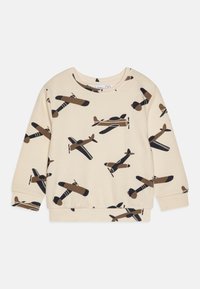 Lys beige genser med et gjentakende mønster av vintage fly i brunt og svart. Ribbestrikkede mansjetter og kant. Myk stofftekstur.