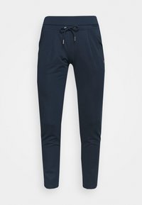 Mörkblå mjukisbyxor i mjukt tyg, med dragsko i midjan, två sidofickor och en smal passform.