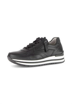 Black leather sneaker with lace-up front, side zipper, white and black striped sole, and padded collar on a white background.