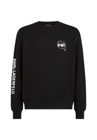 Schwarzer Rundhalsausschnitt-Pullover mit weißem "Karl Lagerfeld"-Text auf dem rechten Ärmel und einem kleinen Cartoon-Gesicht mit Sonnenbrille auf der linken Brust.