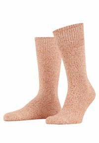 Gestickte Socken in einem sanften Pfirsichton mit gesprenkelten roten Akzenten. Sie verfügen über einen gerippten Saum und eine glatte Textur im gesamten Bereich.