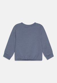 Blå bomull langermet genser med rund hals, elastisk midje og mansjetter. Glatt tekstur og avslappet passform.