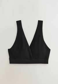 Svart ribbad bralette med breda axelband, djup V-ringning och sömlösa kanter. Mjuk textur och stretchy material för komfort.